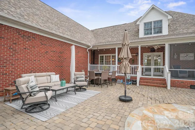 a view of a patio with a table and chairs
