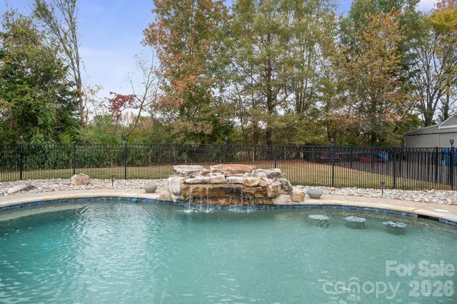 a view of a swimming pool with a yard