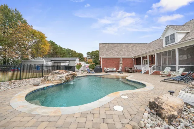 a view of swimming pool with outdoor seating and plants