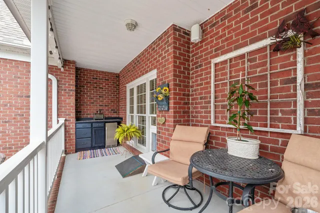 a view of swimming pool with outdoor seating and plants