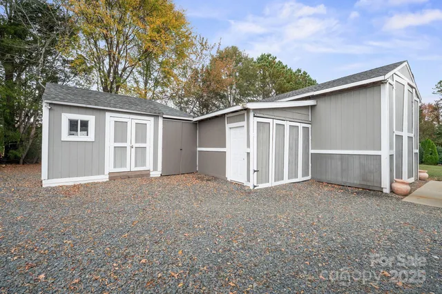a view of a dining room with furniture and a chandelier