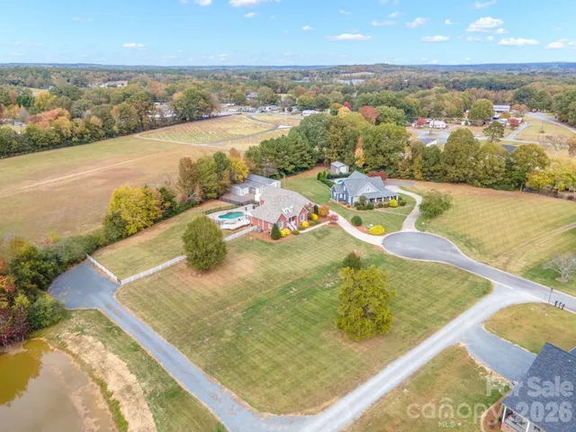 front view of house with yard and trees in the background
