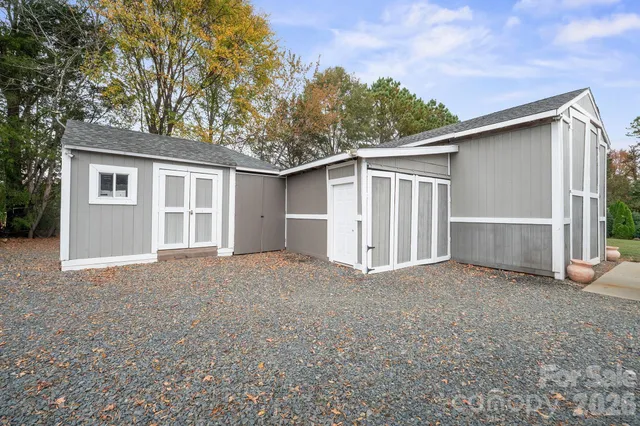 a view of a dining room with furniture and a chandelier