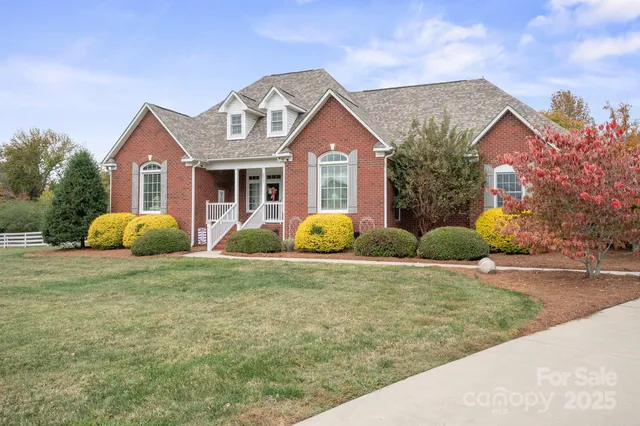 a front view of a house with garden and plants