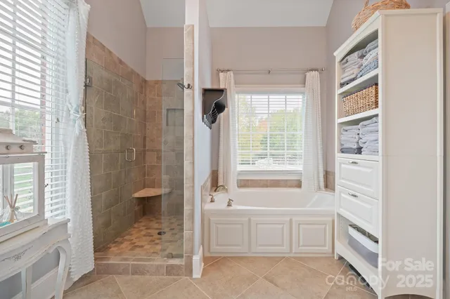 a bathroom with a tub shower and sink