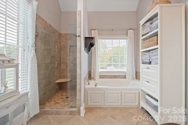 a bathroom with a tub sink and a shower