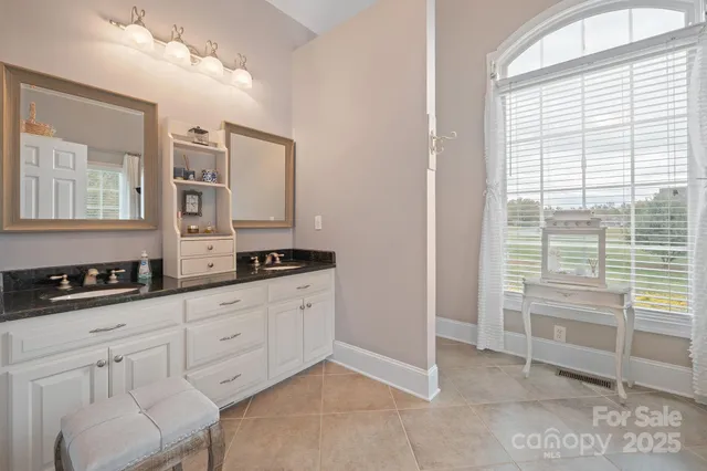 a kitchen with granite countertop a sink and a stove