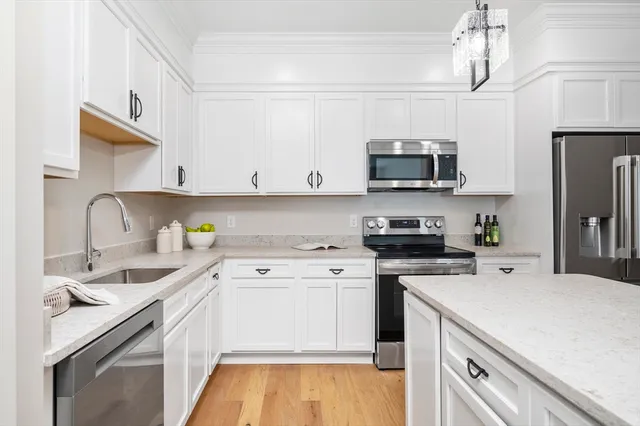 a kitchen with a sink stove and cabinets