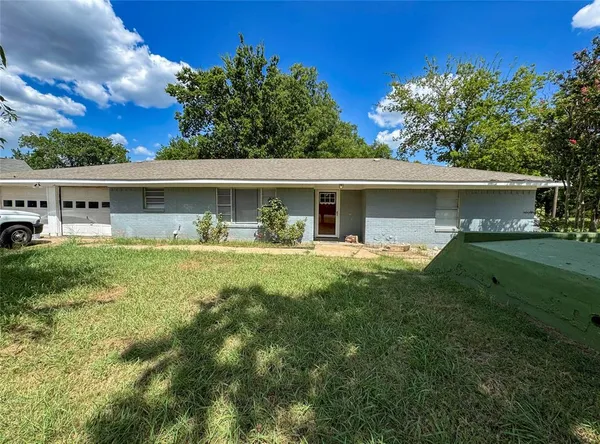 a view of house with backyard space and garden