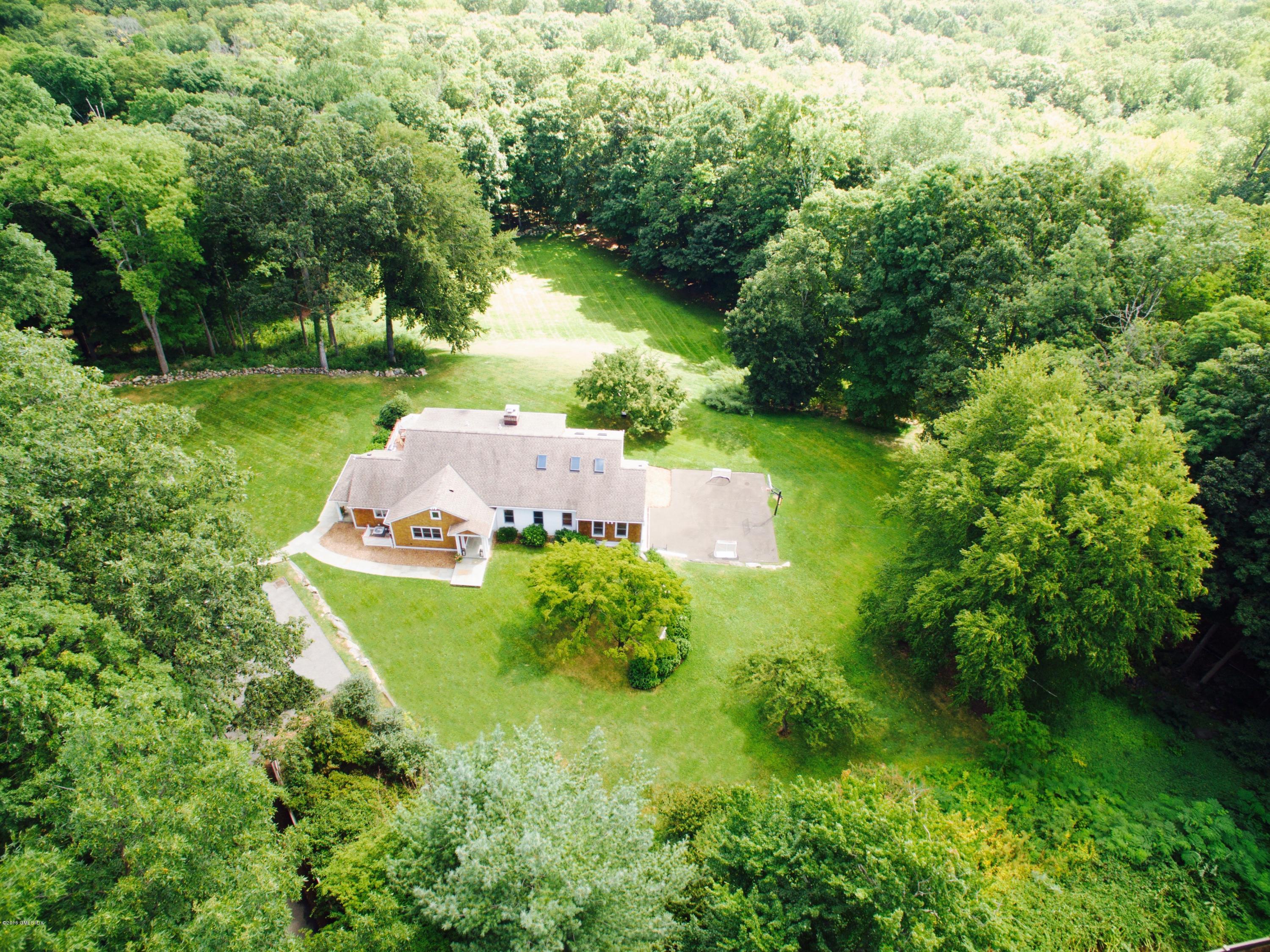 102 Hunting Ridge Road Greenwich, CT 06831 - Photo 1 of 29 an aerial view of a house with a yard