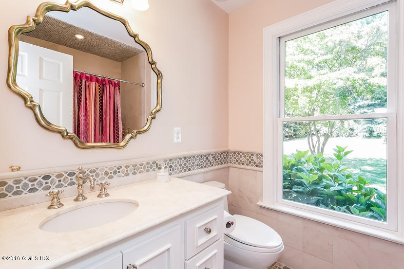 102 Hunting Ridge Road Greenwich, CT 06831 - Photo 17 of 29 a bathroom with a sink a toilet and a mirror
