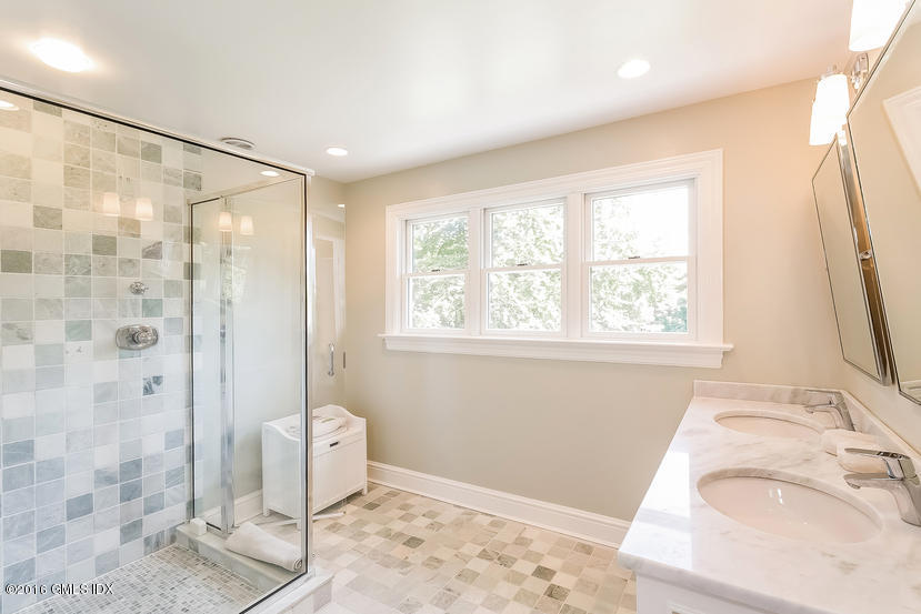 102 Hunting Ridge Road Greenwich, CT 06831 - Photo 23 of 29 a bathroom with a granite countertop sink a toilet and shower