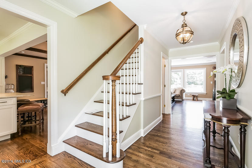 102 Hunting Ridge Road Greenwich, CT 06831 - Photo 6 of 29 a view of a hallway to a livingroom with wooden floor and furniture