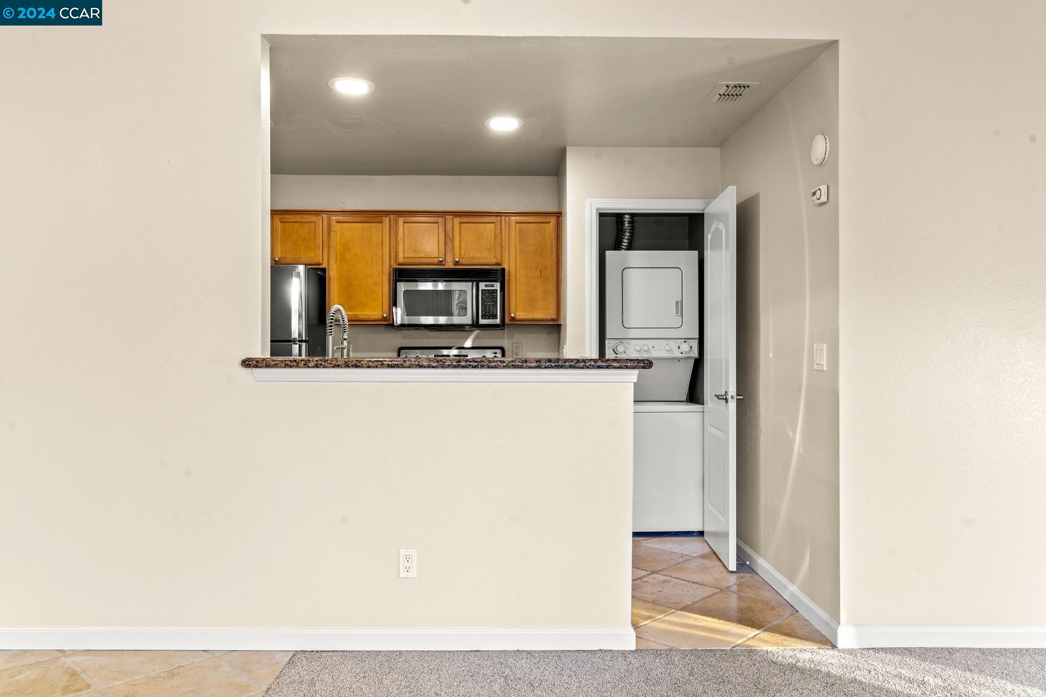 285 Reflections Drive, Unit 25 San Ramon, CA 94583 - Photo 13 of 42 a view of kitchen with stainless steel appliances wooden floor