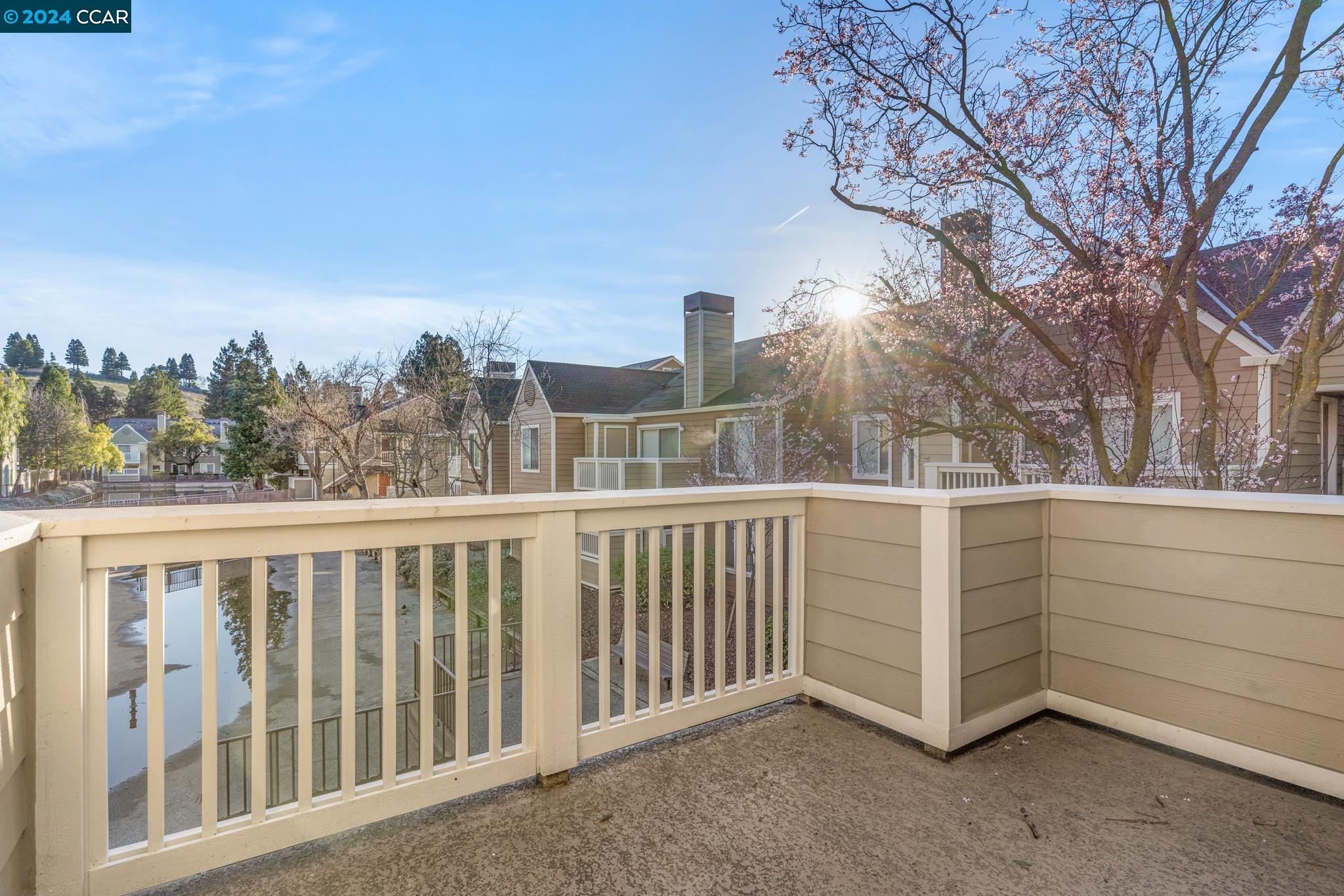 285 Reflections Drive, Unit 25 San Ramon, CA 94583 - Photo 18 of 42 a view of a white house with a large window and wooden fence