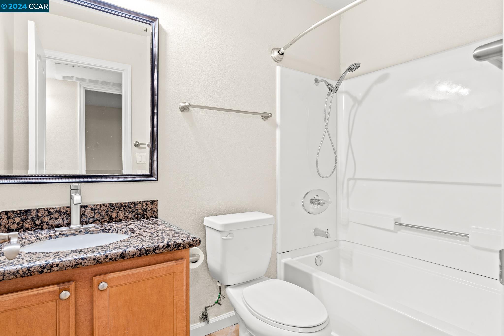 285 Reflections Drive, Unit 25 San Ramon, CA 94583 - Photo 19 of 42 a bathroom with a granite countertop toilet sink and shower