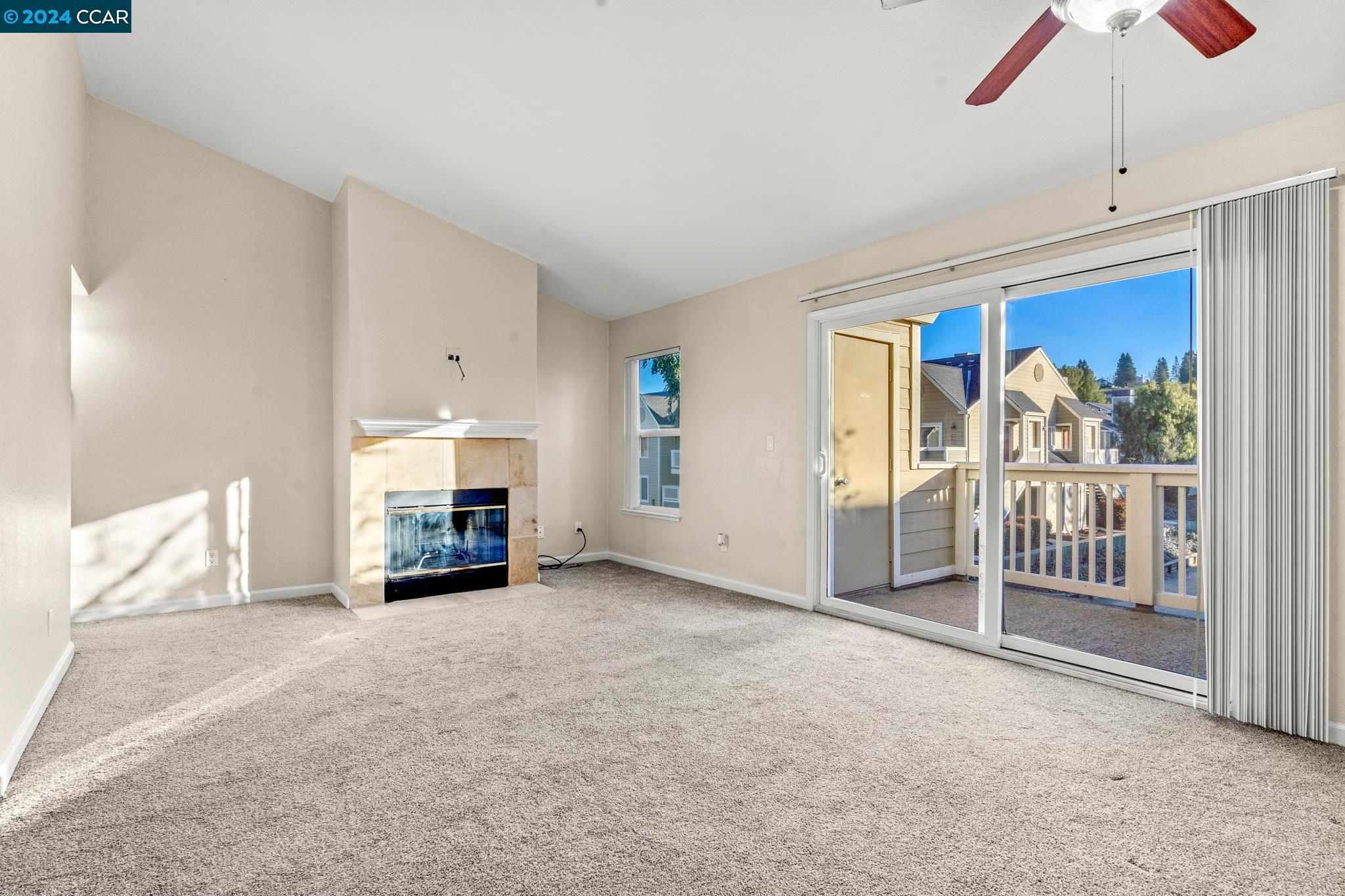 285 Reflections Drive, Unit 25 San Ramon, CA 94583 - Photo 5 of 42 a view of a livingroom with a fireplace and window