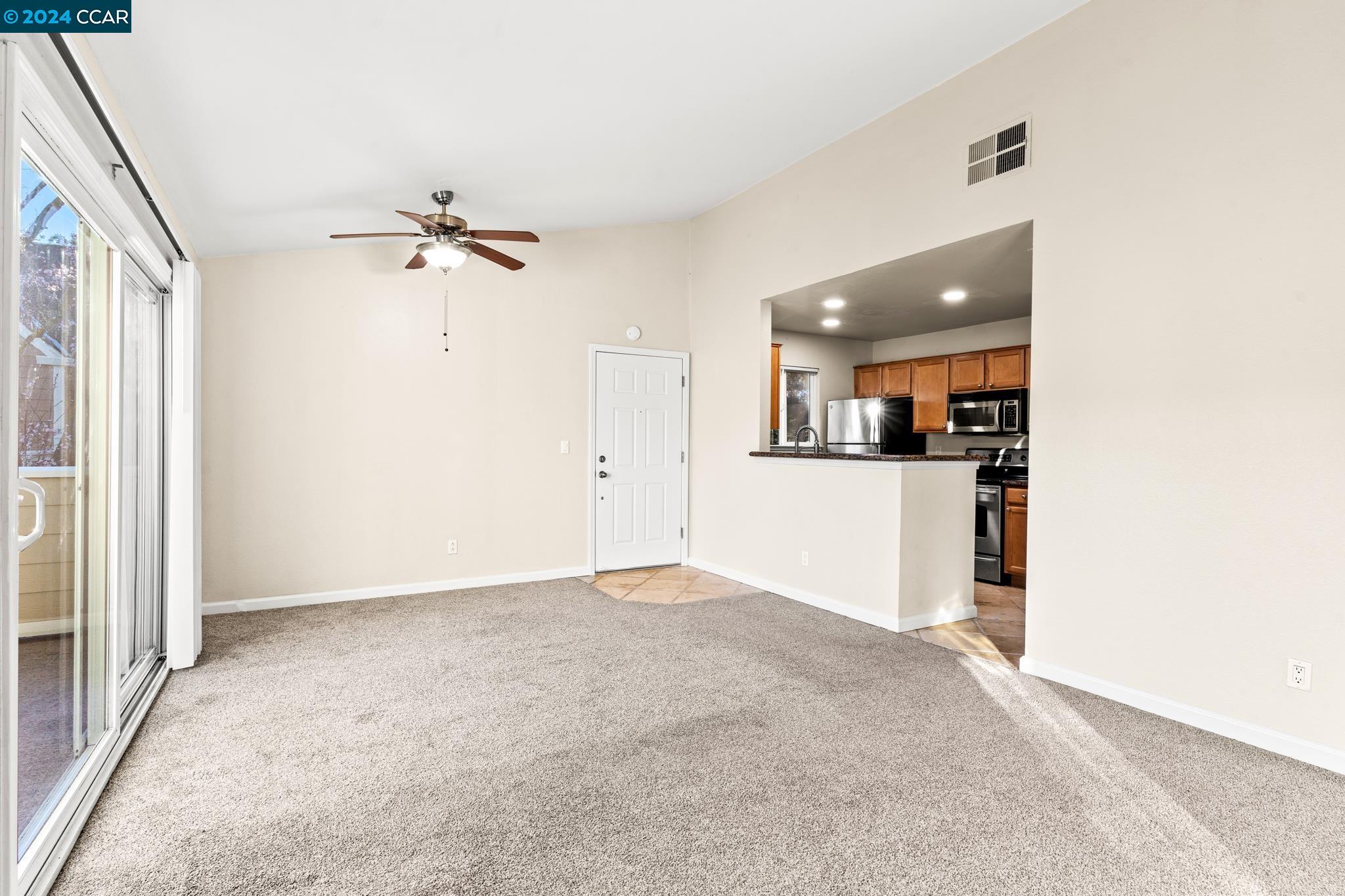 285 Reflections Drive, Unit 25 San Ramon, CA 94583 - Photo 7 of 42 an empty room with cabinet and windows