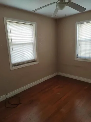 a view of an empty room and wooden floor