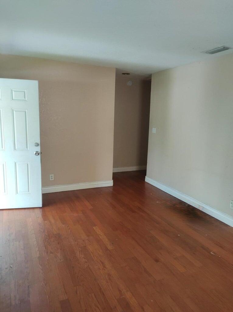 587 West 4th Street Riviera Beach, FL 33404 - Photo 8 of 10 a view of an empty room and wooden floor