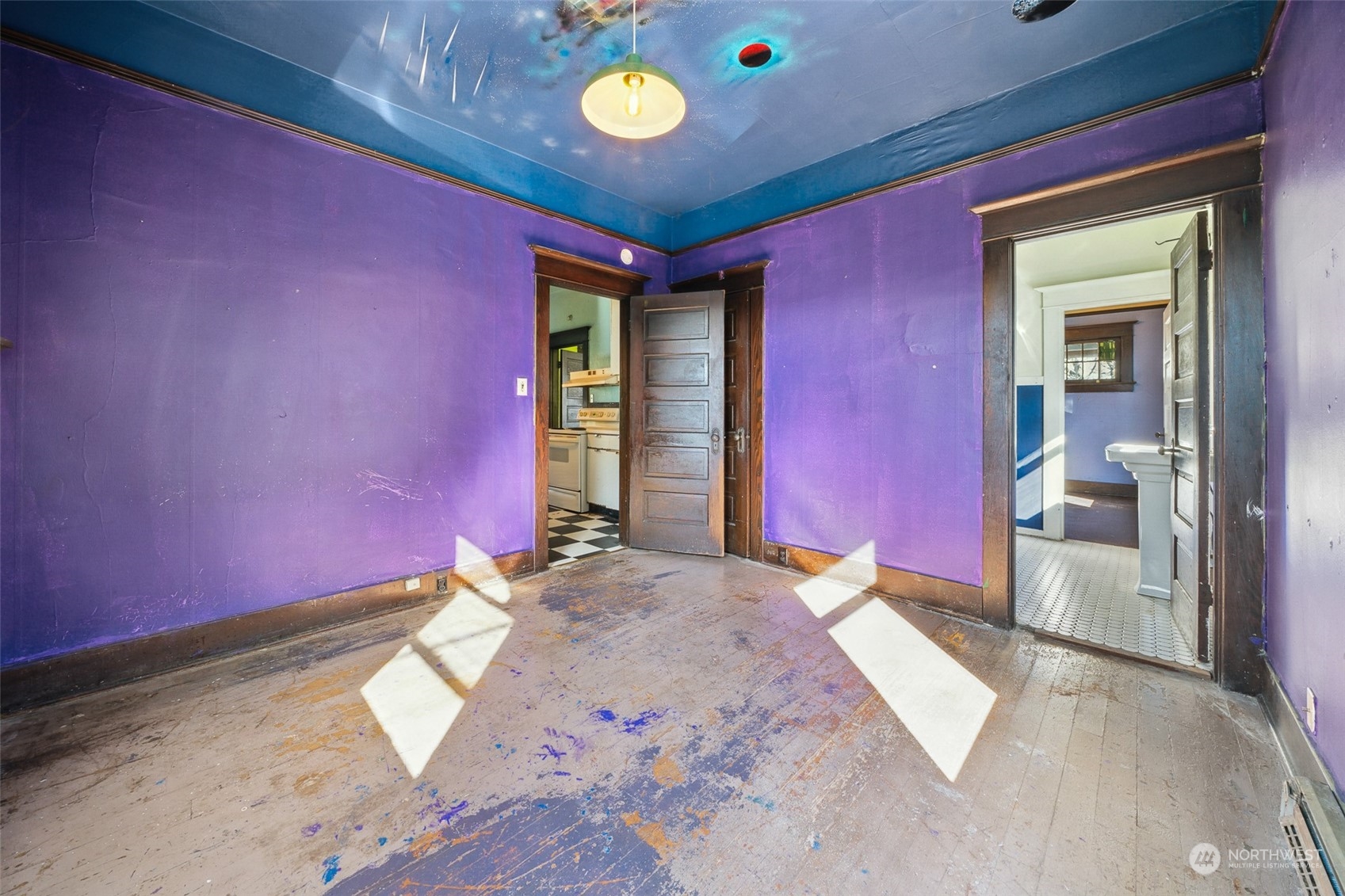 3840 Linden Avenue North Seattle, WA 98103 - Photo 32 of 40 a bedroom with a bed and a chandelier