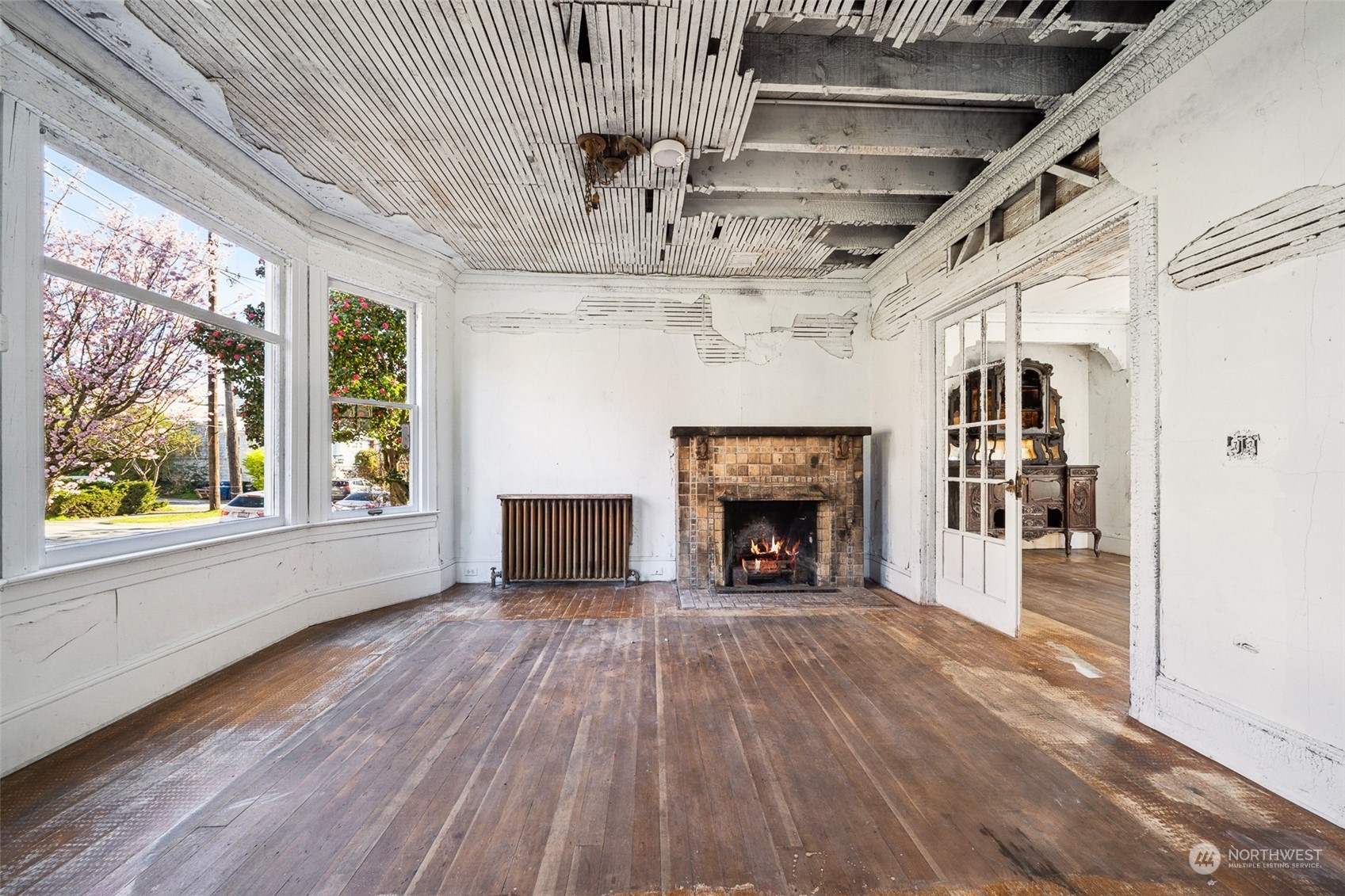 3840 Linden Avenue North Seattle, WA 98103 - Photo 5 of 40 a view of empty room with wooden floor and fireplace