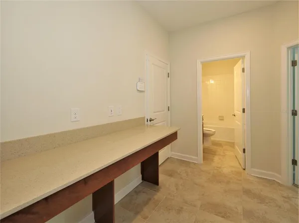 a bathroom with a granite countertop toilet a sink and a bathtub