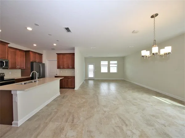 a kitchen with stainless steel appliances a refrigerator a sink dishwasher a oven and a refrigerator