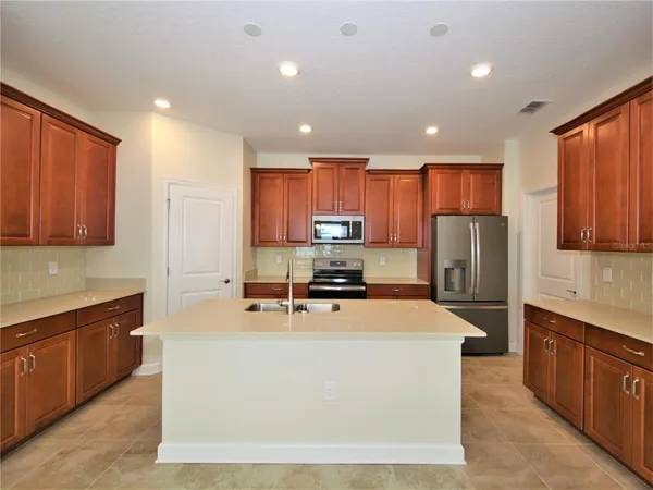 a kitchen with a sink a stove a microwave and refrigerator