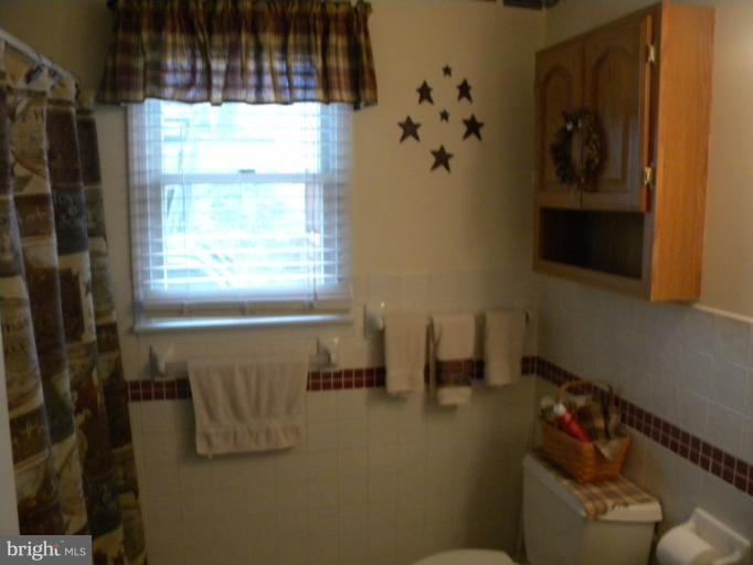 2930 Apple Pie Ridge Road Winchester, VA 22603 - Photo 12 of 24 a bathroom with a bathtub and a window