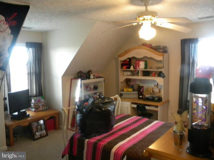 2930 Apple Pie Ridge Road Winchester, VA 22603 - Photo 13 of 24 a bedroom with a bed and a chandelier