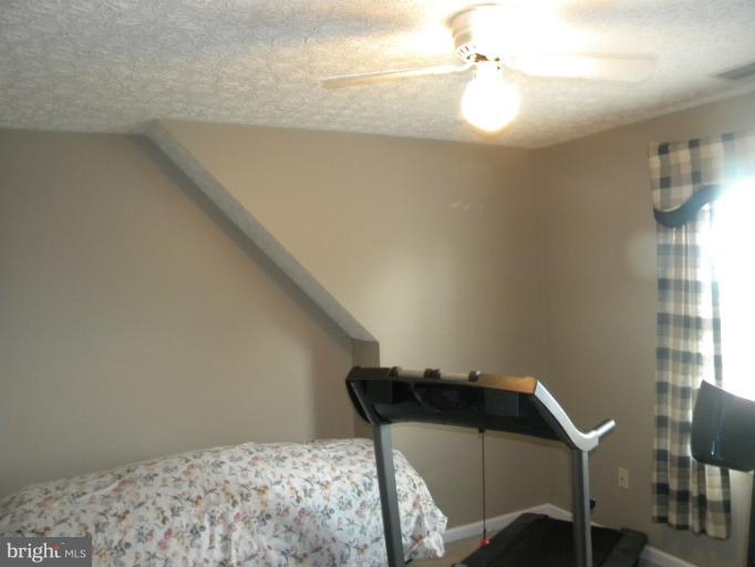 2930 Apple Pie Ridge Road Winchester, VA 22603 - Photo 19 of 24 a bedroom with a bed and a table in it