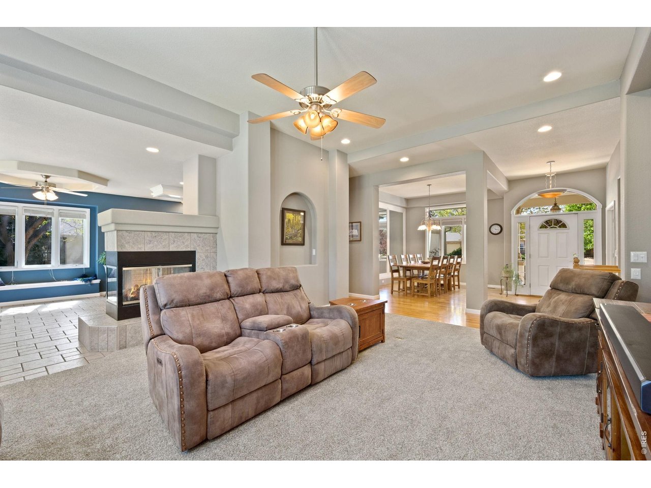527 Valley View Road Loveland, CO 80537 - Photo 11 of 46 Living Room Open to Kitchen with 3-Sided Fireplace