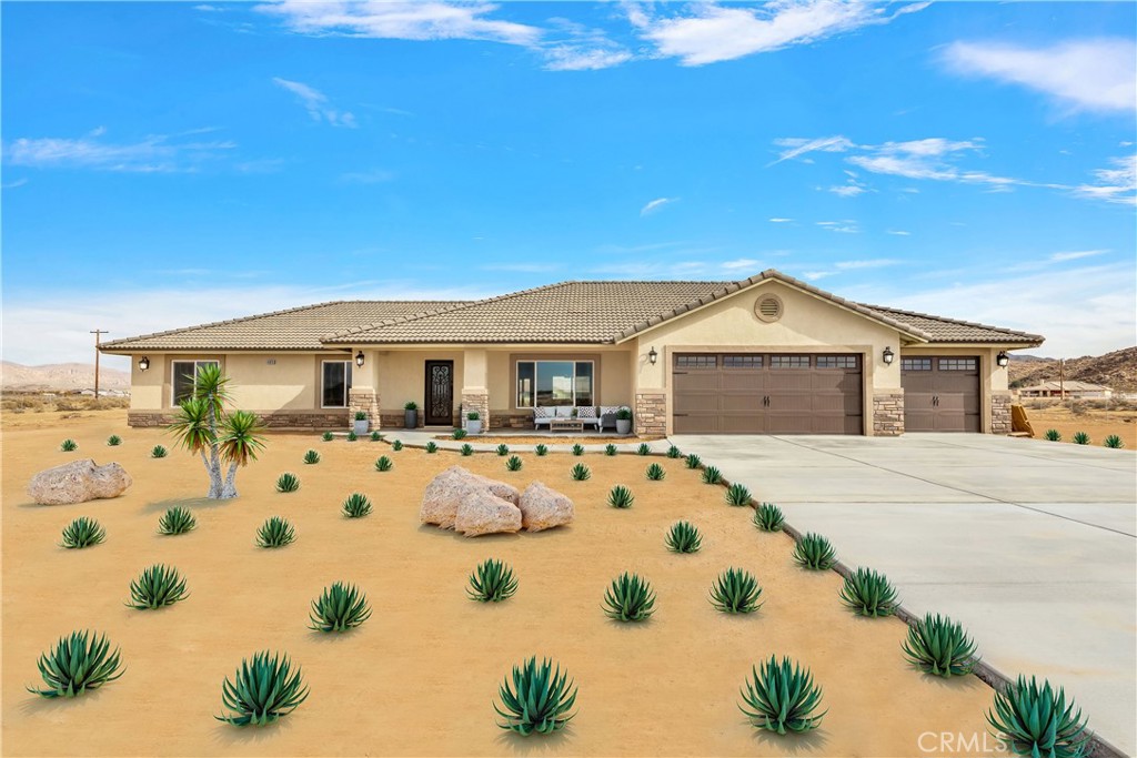 14875 Pela Road Apple Valley, CA 92307 - Photo 1 of 1 a front view of a house with garden
