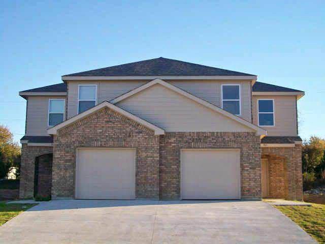 a front view of a house with yard