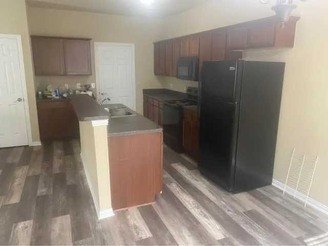 a kitchen with a sink and refrigerator