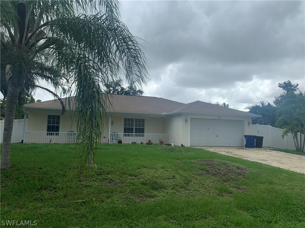 18599 Flamingo Road Fort Myers, FL 33967 - Photo 1 of 30 a backyard of a house with table and chairs