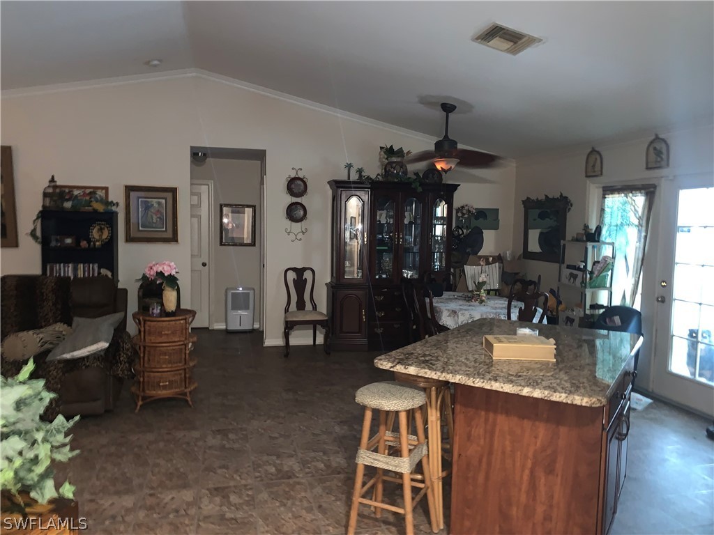 18599 Flamingo Road Fort Myers, FL 33967 - Photo 14 of 30 a living room with fireplace furniture and a chandelier