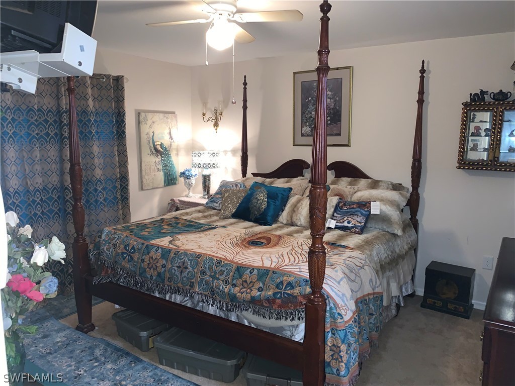 18599 Flamingo Road Fort Myers, FL 33967 - Photo 17 of 30 a bedroom with a bed and a chandelier