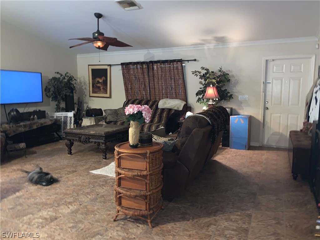 18599 Flamingo Road Fort Myers, FL 33967 - Photo 20 of 30 a living room with furniture a lamp and a fireplace