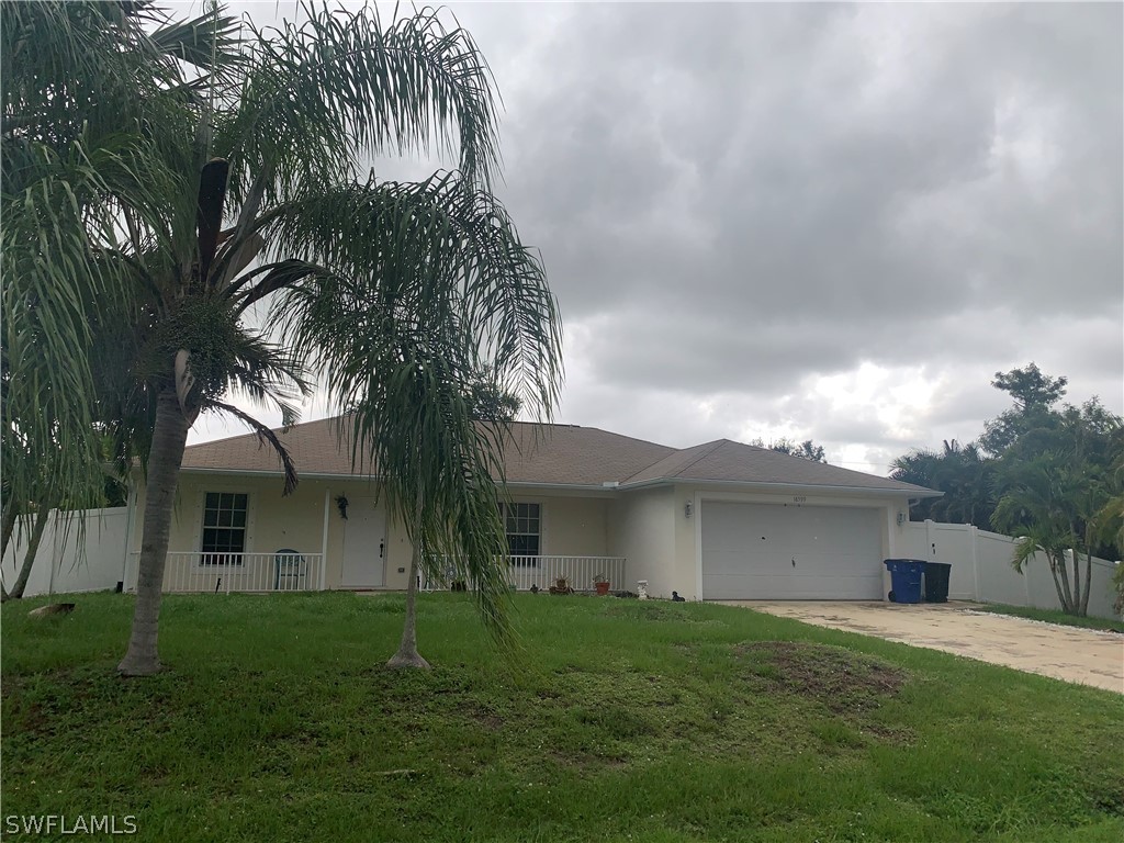 18599 Flamingo Road Fort Myers, FL 33967 - Photo 22 of 30 a front view of a house with a garden and yard