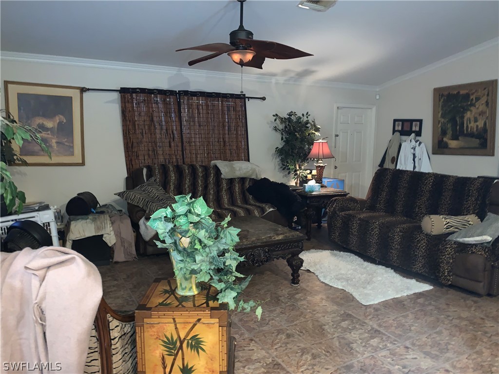 18599 Flamingo Road Fort Myers, FL 33967 - Photo 26 of 30 a living room with furniture a chandelier and a window