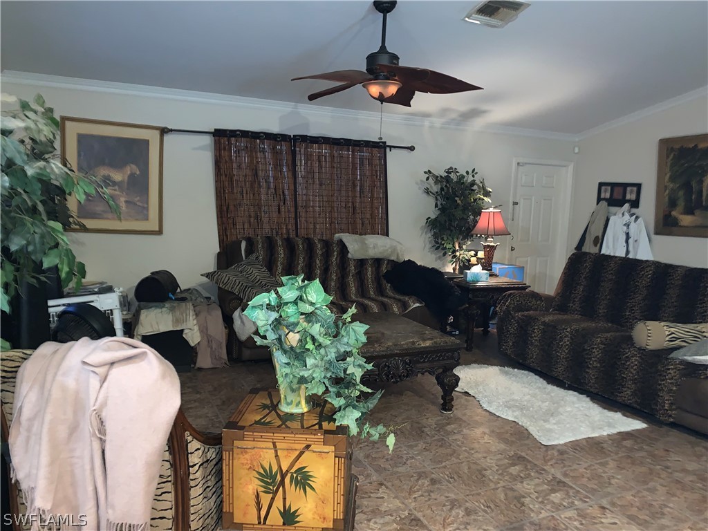 18599 Flamingo Road Fort Myers, FL 33967 - Photo 27 of 30 a living room with furniture a chandelier and a window