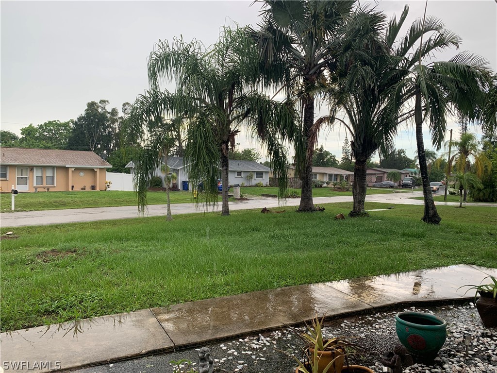 18599 Flamingo Road Fort Myers, FL 33967 - Photo 28 of 30 front view of a house with a yard and potted plants