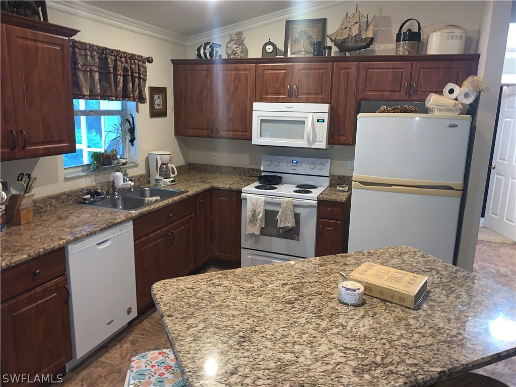 18599 Flamingo Road Fort Myers, FL 33967 - Photo 3 of 30 a kitchen with a sink a stove and refrigerator