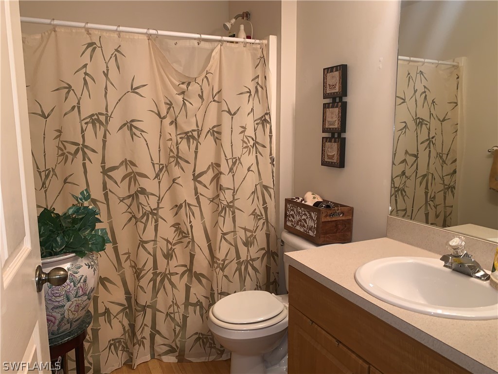 18599 Flamingo Road Fort Myers, FL 33967 - Photo 6 of 30 a bathroom with a granite countertop sink and a toilet