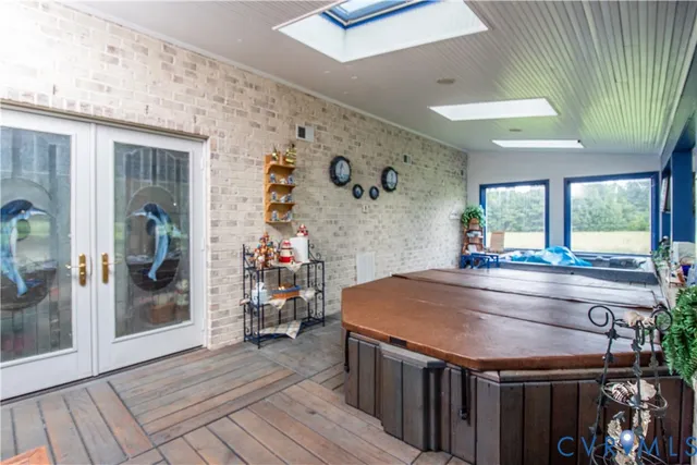 a living room with patio furniture and floor to ceiling windows