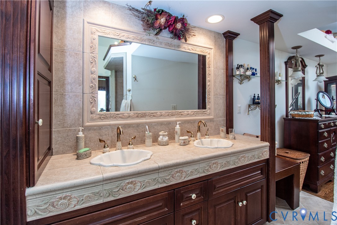 5301 Middle Road Prince George, VA 23875 - Photo 8 of 22 a bathroom with a granite countertop sink a large mirror and a shower