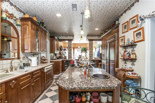 a kitchen with stainless steel appliances granite countertop a sink and cabinets