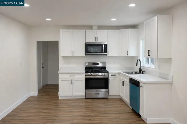 a kitchen with a sink stove and cabinets